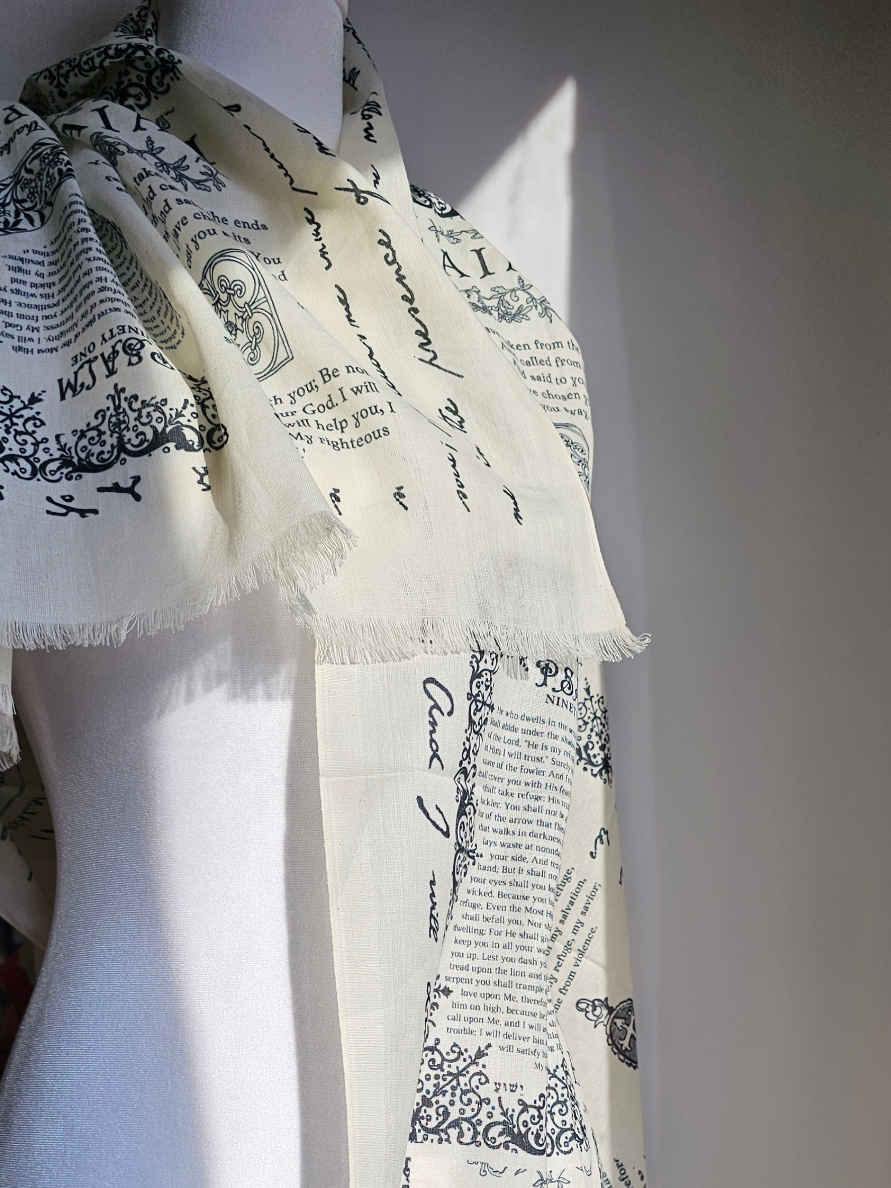 Cotton protection prayer scarf by Prayer Scarves® in ivory, shown in a close-up detail highlighting the fringe edge and Scripture-printed fabric, made from organic cotton
