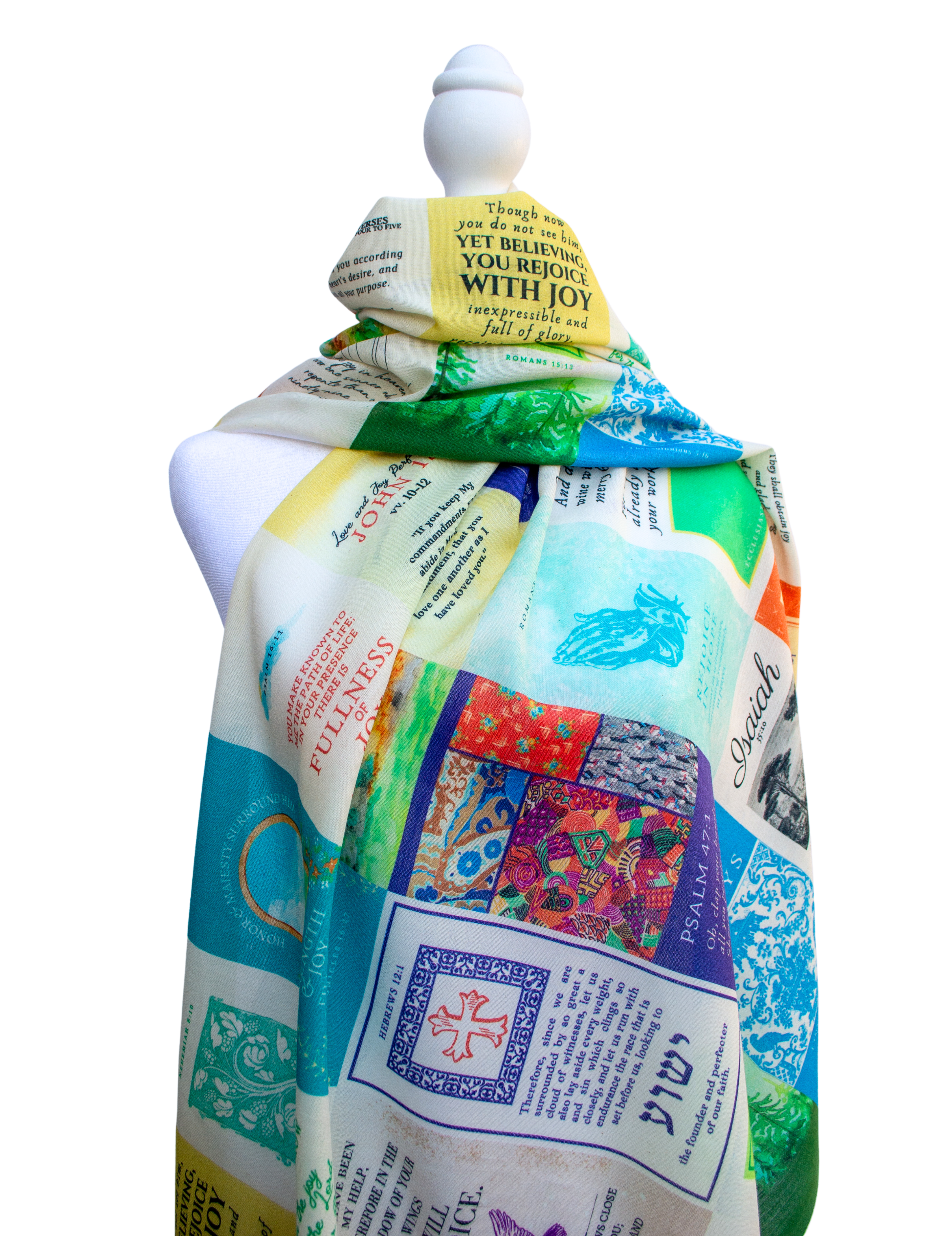 Joy Cotton prayer scarf by Prayer Scarves® displayed on a white mannequin, featuring a multicolor patchwork-style design with scripture text blocks, decorative patterns, and visible phrases including “Yet believing you rejoice with joy,”.