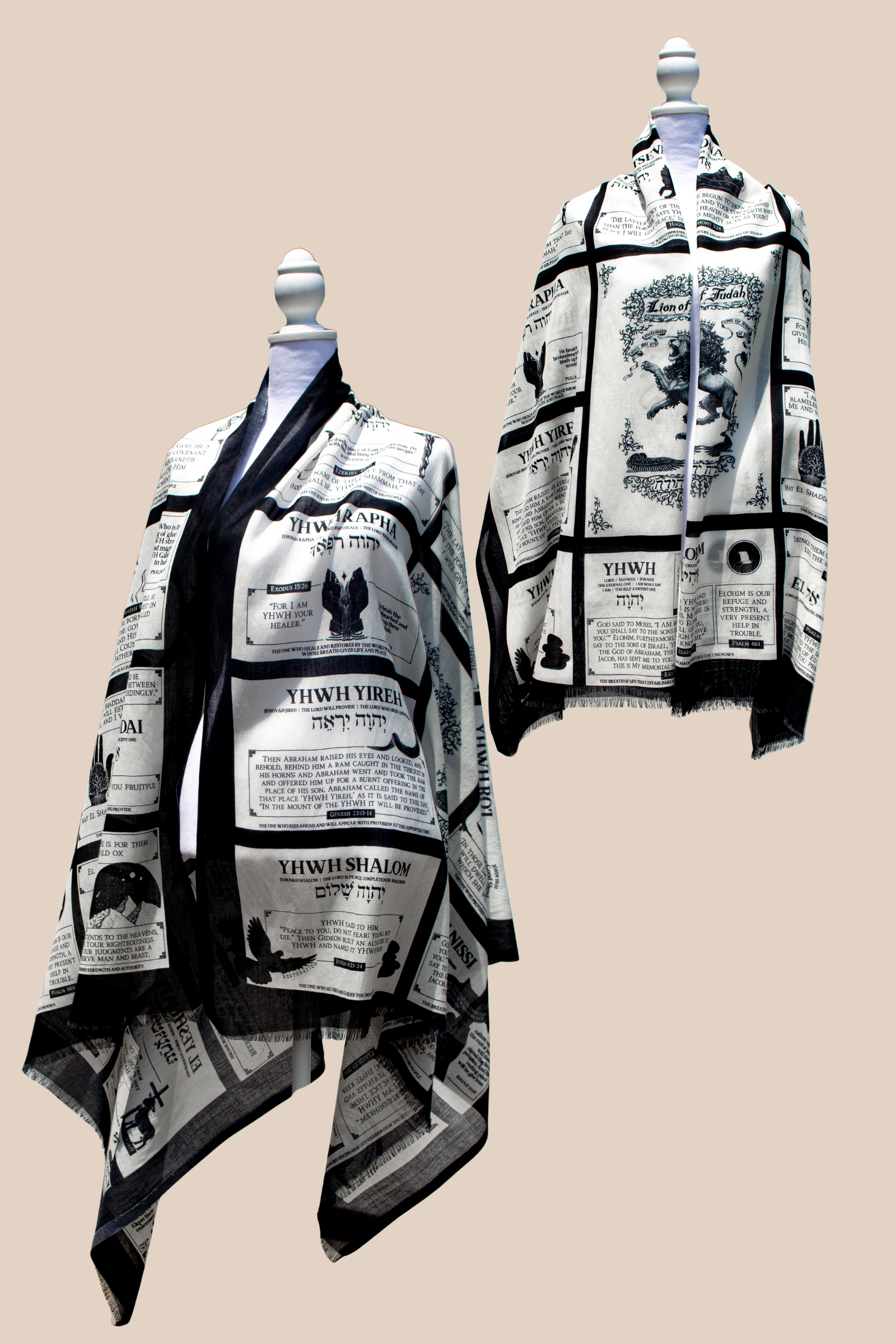 A product display showing two views of the white and black Names of God protection prayer scarf on mannequins. One mannequin shows the Prayer Scarves® garment draped to highlight the Names of God grid, while the other emphasizes the central Lion of Judah artwork and Scripture passages about God’s protection, such as those from Exodus and the Psalms.