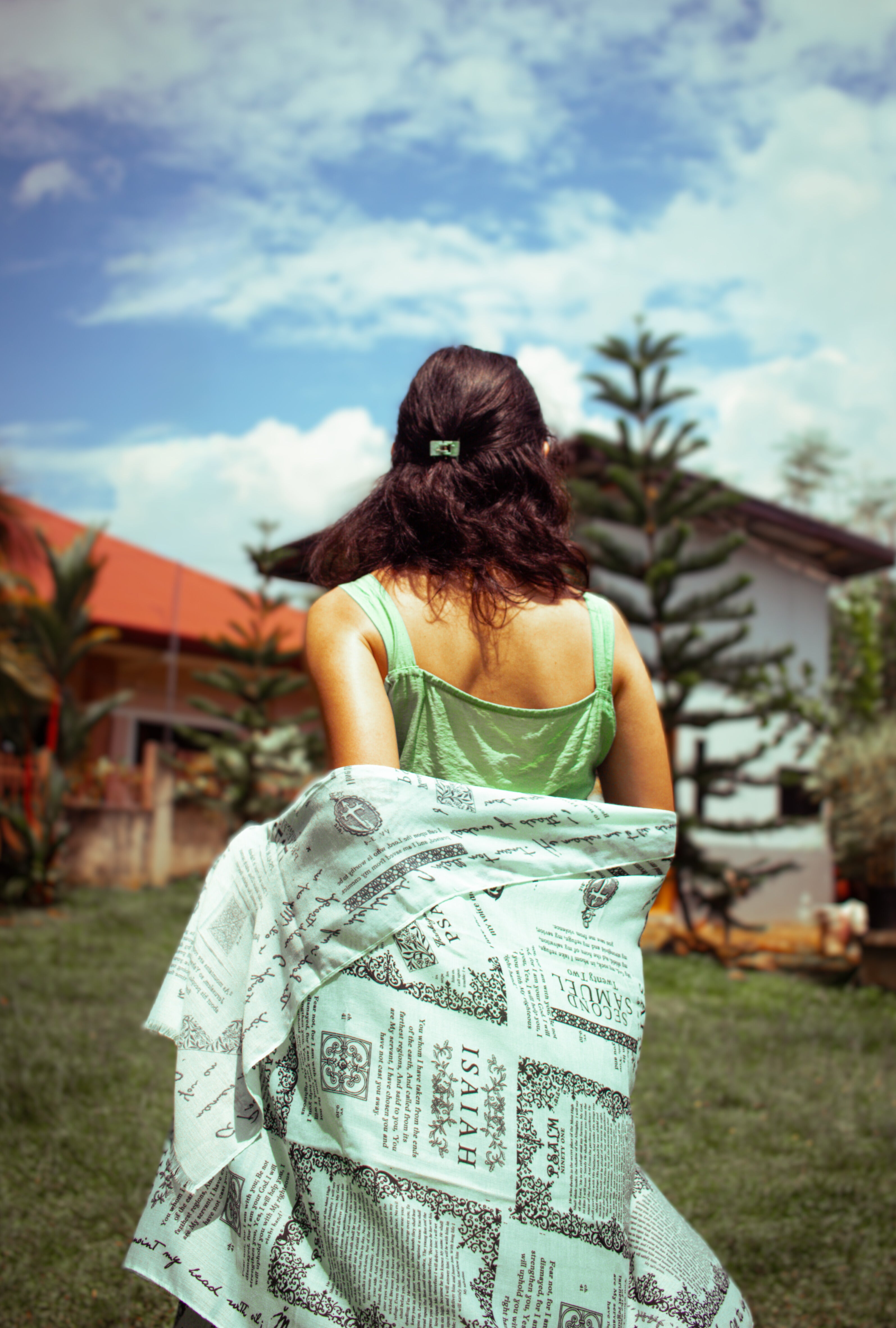 Protection prayer scarf by Prayer Scarves® in honeydew green, draped around the shoulders outdoors, featuring Scripture passages about God’s protection from Psalms and Isaiah, shown as a gentle visual reminder of prayer and trust in God