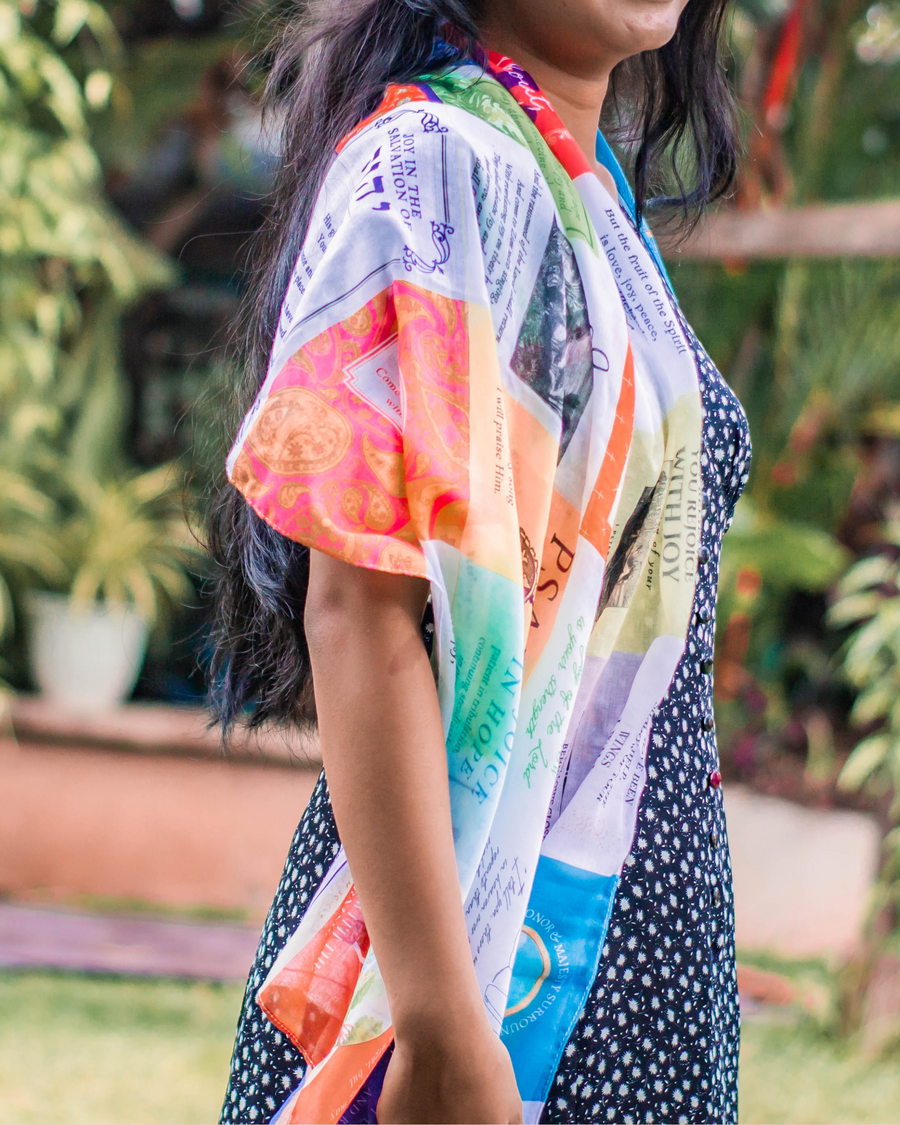 Joy prayer scarf by Prayer Scarves® shown worn over the shoulder, highlighting its lightweight fabric and vibrant Scripture panels focused on joy, praise, and life in the Spirit