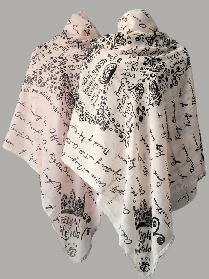 And He Shall Be Called prayer scarf by Prayer Scarves® wrapped and draped around a mannequin, featuring handwritten and illustrated names and titles of Jesus throughout the design